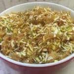 Vermicelli sheera in a bowl garnished with nuts and raisins