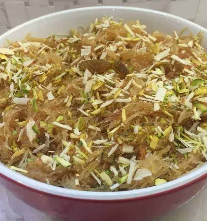 Vermicelli sheera in a bowl garnished with nuts and raisins