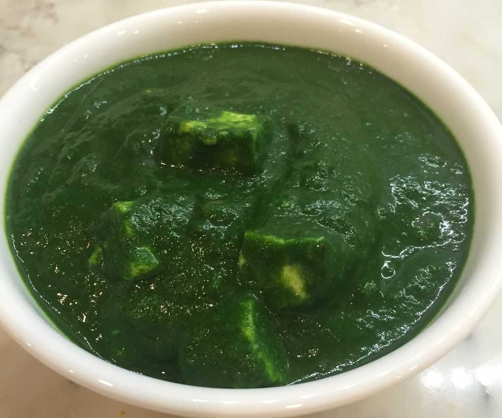 Palak Paneer in a white bowl 