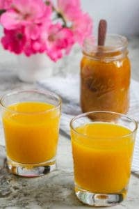 two glasses of mango panha and jar of mango jam