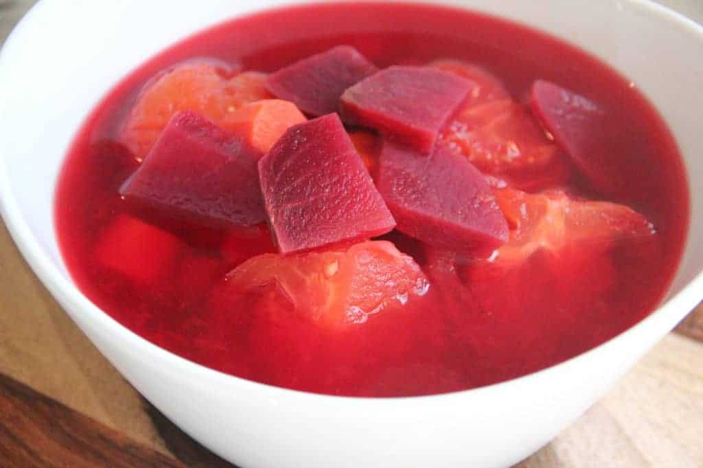 boiled carrots, beets and tomatoes in a bowl 