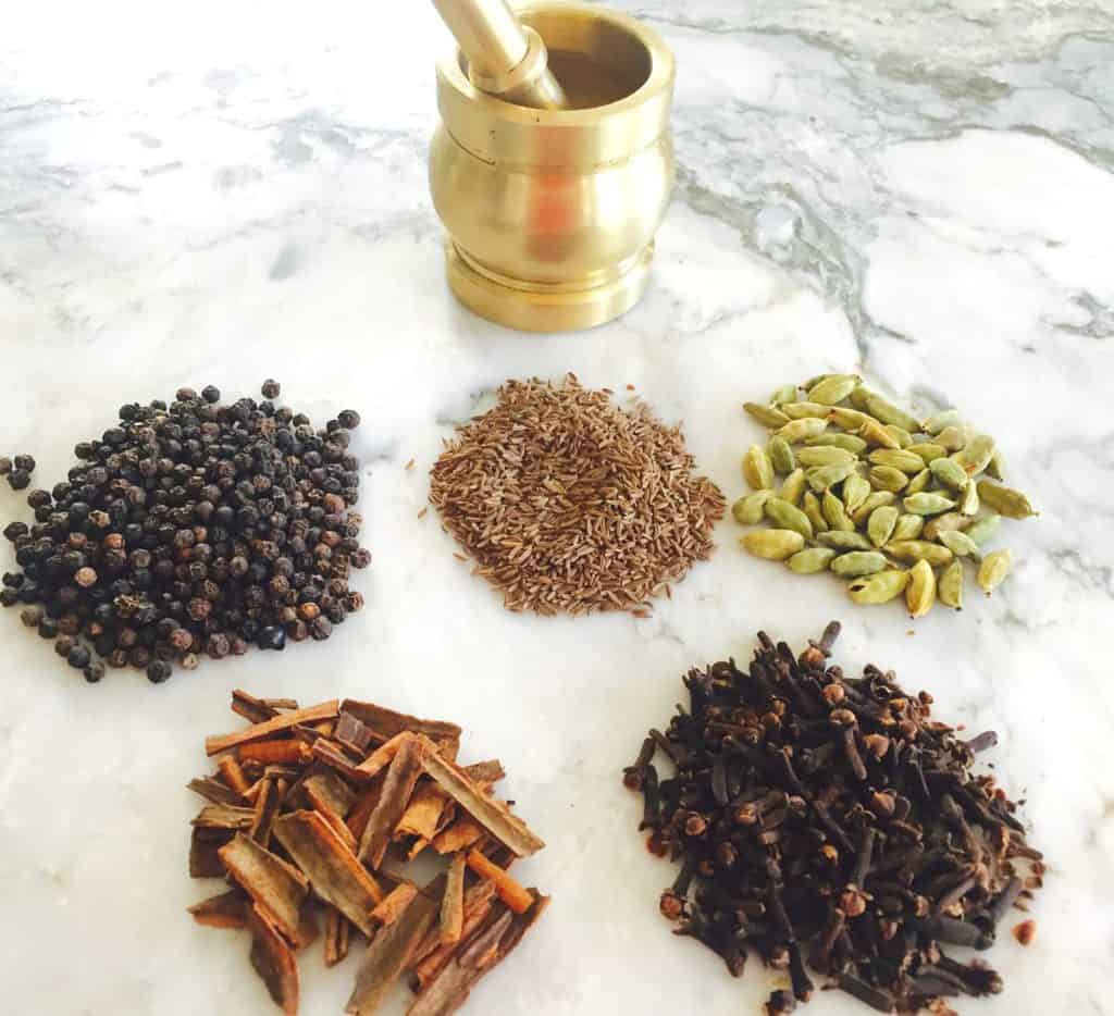 whole spices along side mortar and pestle 