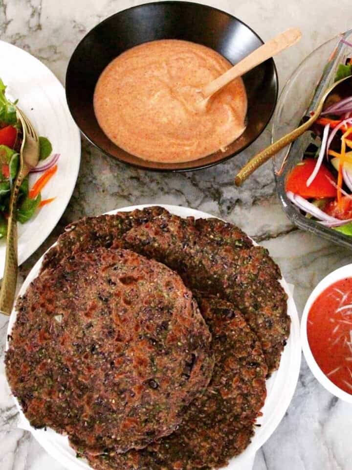 Purple Cabbbage Parathas in a platter with yogurt chutney and salad on the side