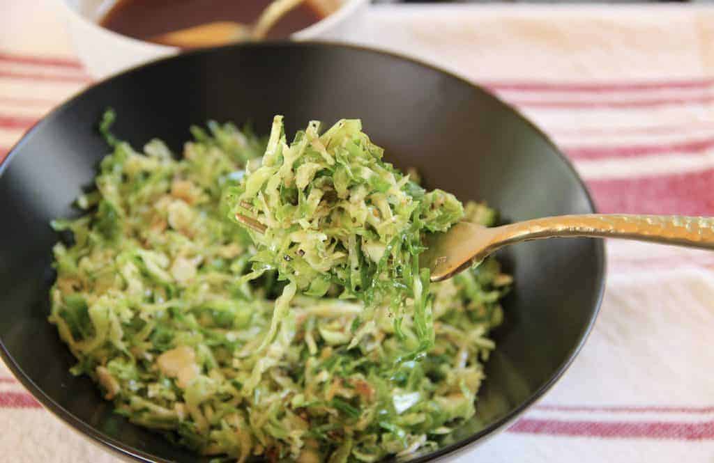 Ginger tamarind brussels sprouts in a black bowl 