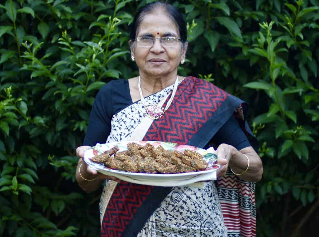 Mother in law holding a platter of kothimbir vadi 