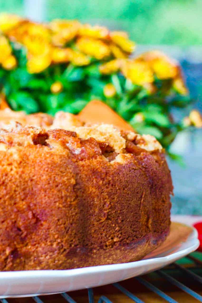 apple cake with orange mums in the background 