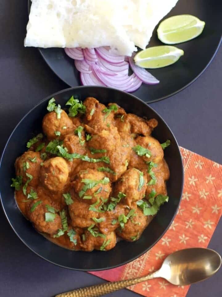 chicken kofta curry in a black bowl