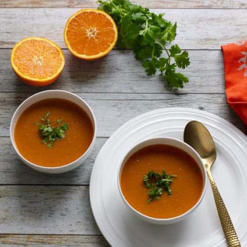 citrusy lentil soup served in 2 white bowls