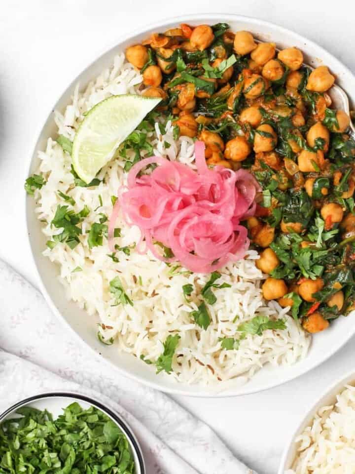 Chana Saag served with rice and pickled onions