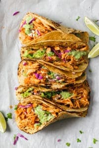 Chicken Tinga Tacos with lemaon wedges on the side