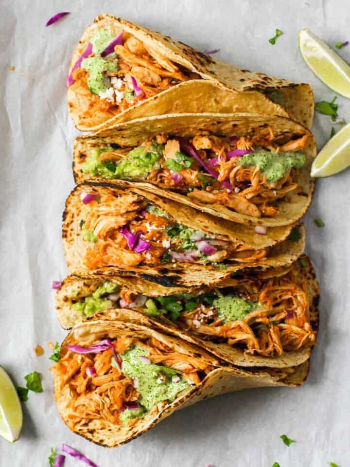 Chicken Tinga Tacos with lemaon wedges on the side