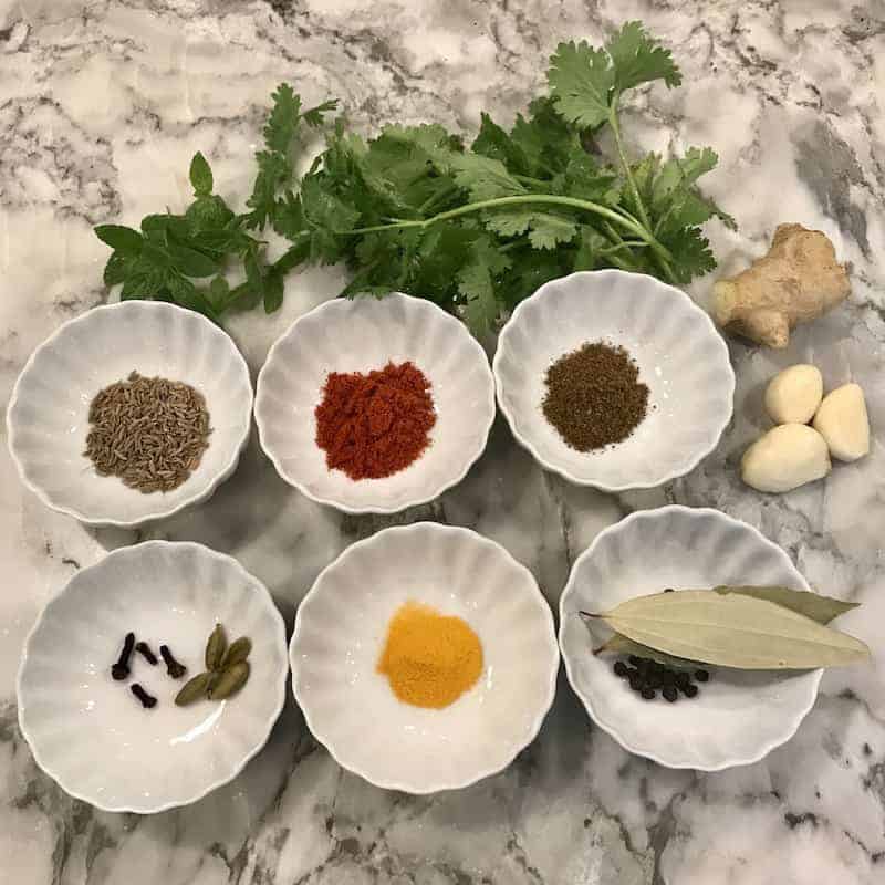spices in white bowls for Vegetable and Paneer Biryani
