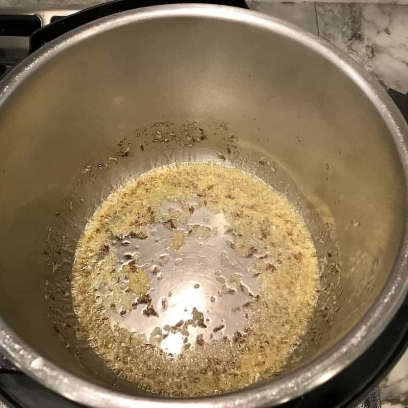 Instant Pot with ghee, cumin seeds and ginger