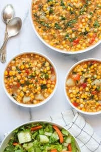 Corn Poblano chowder in 3 white bowls