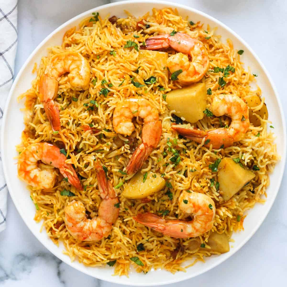 Shrimp Biryani with potatoes served in a large platter.