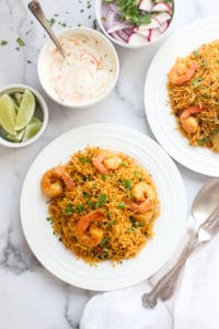 shrimp biryani with raita and lime wedges