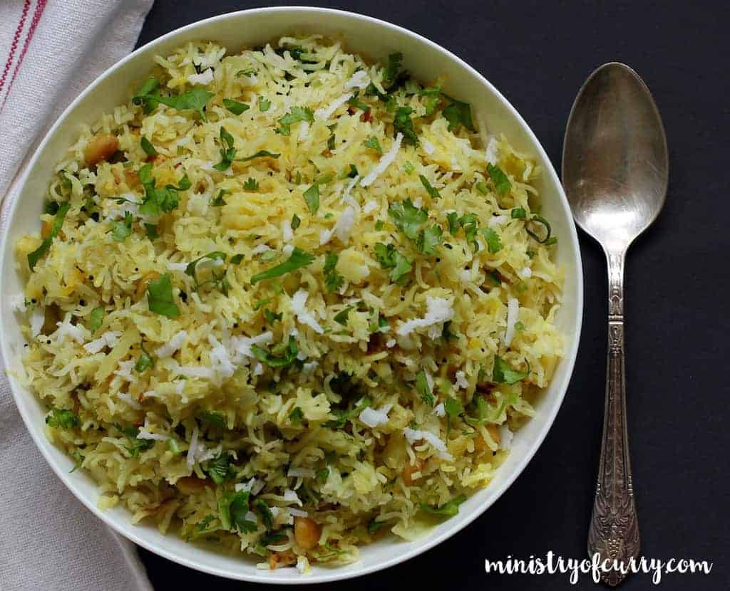 cabbage rice served in a white bowl with a spoon 