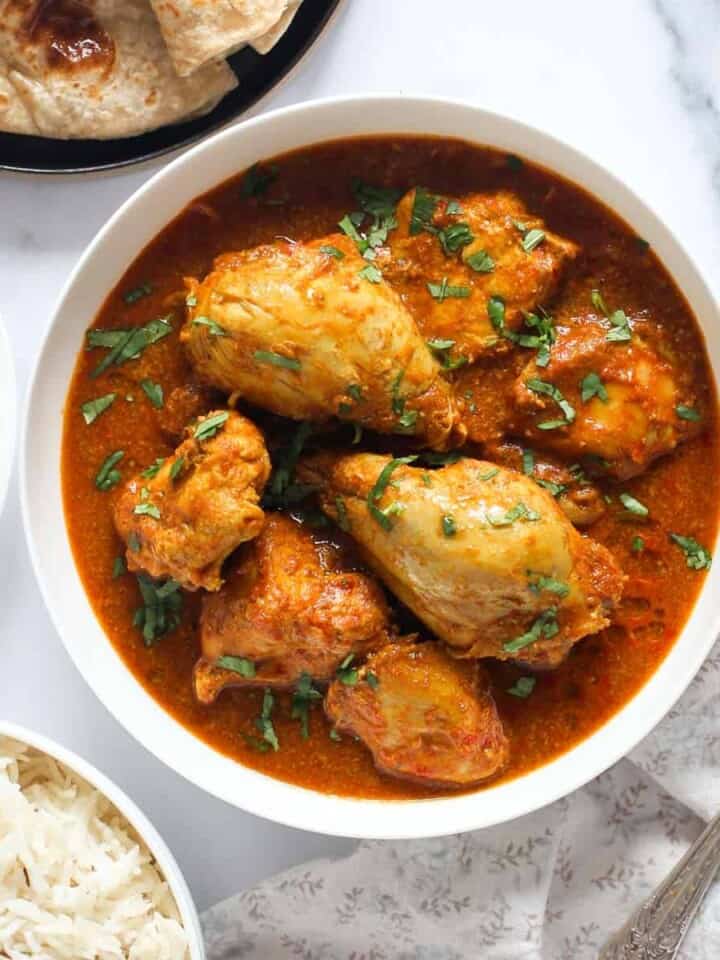 chicken curry served on a white bowl