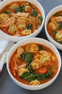 3 white bowls with chicken tortellini soup