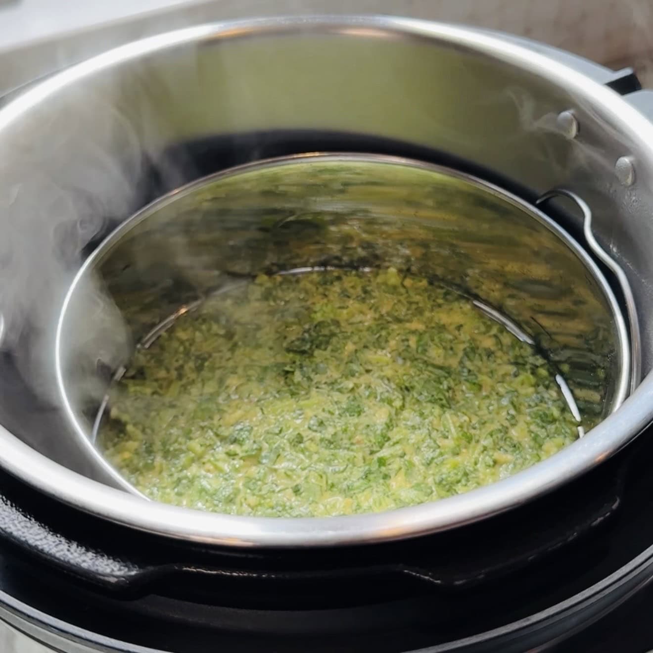 Kothimbir vadi batter steaming inside Instant Pot.