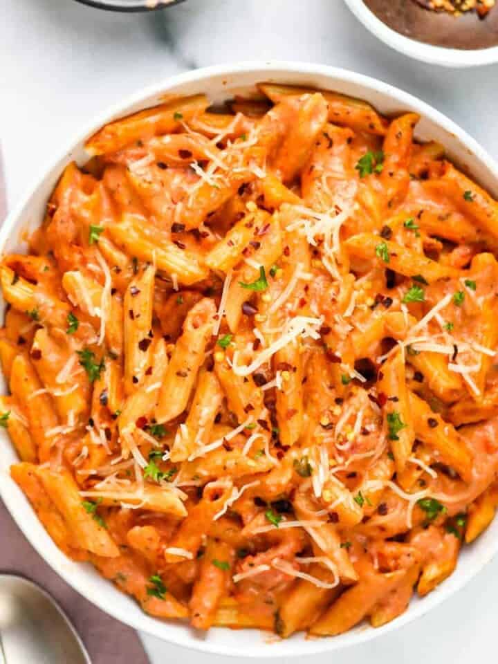 pasta with tomato cream sauce served in a white bowl