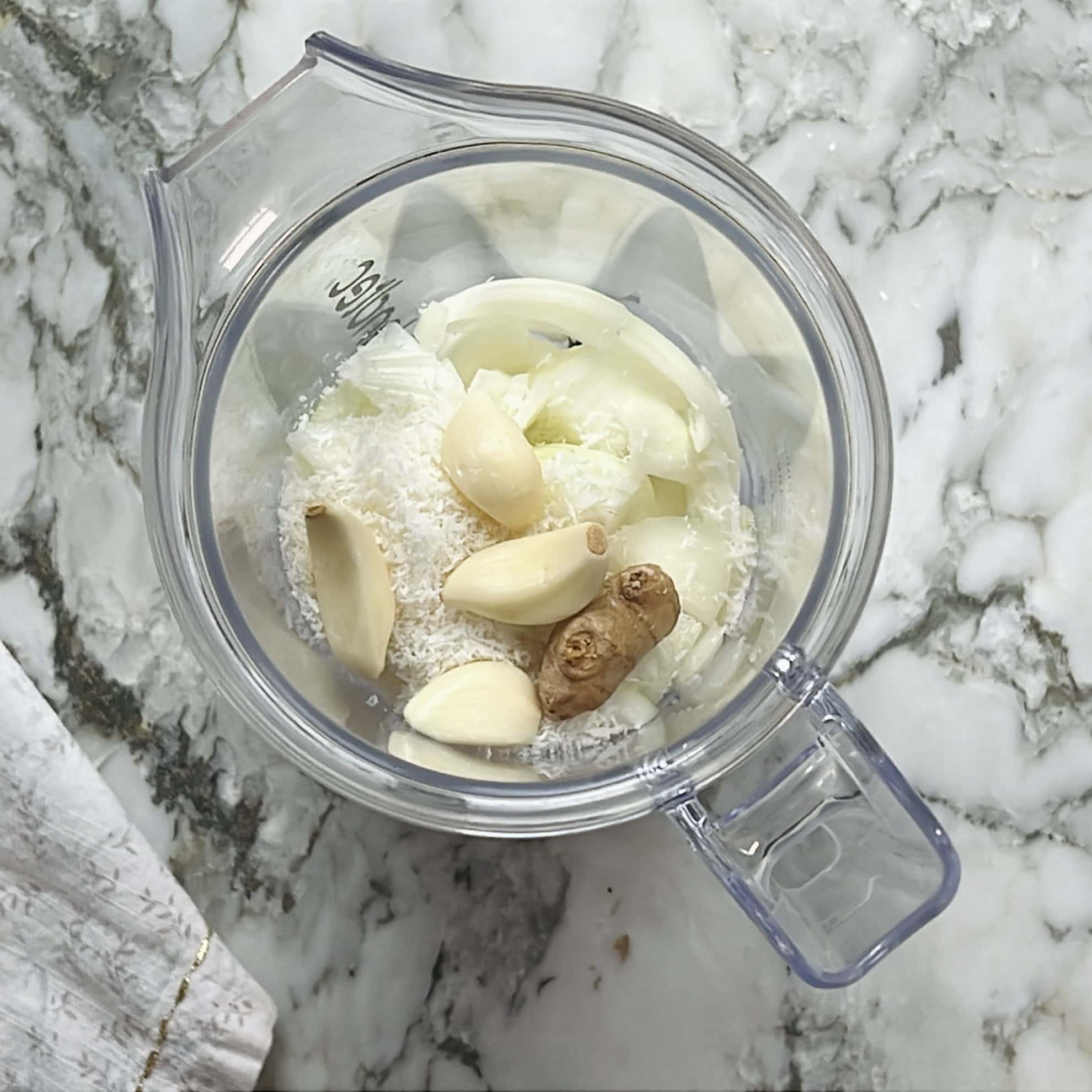 onion, coconut, ginger and garlic in a blender jar.