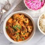 shahi chicken korma served with rice and raita.