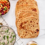 square parathas with a silver bowl of ghee