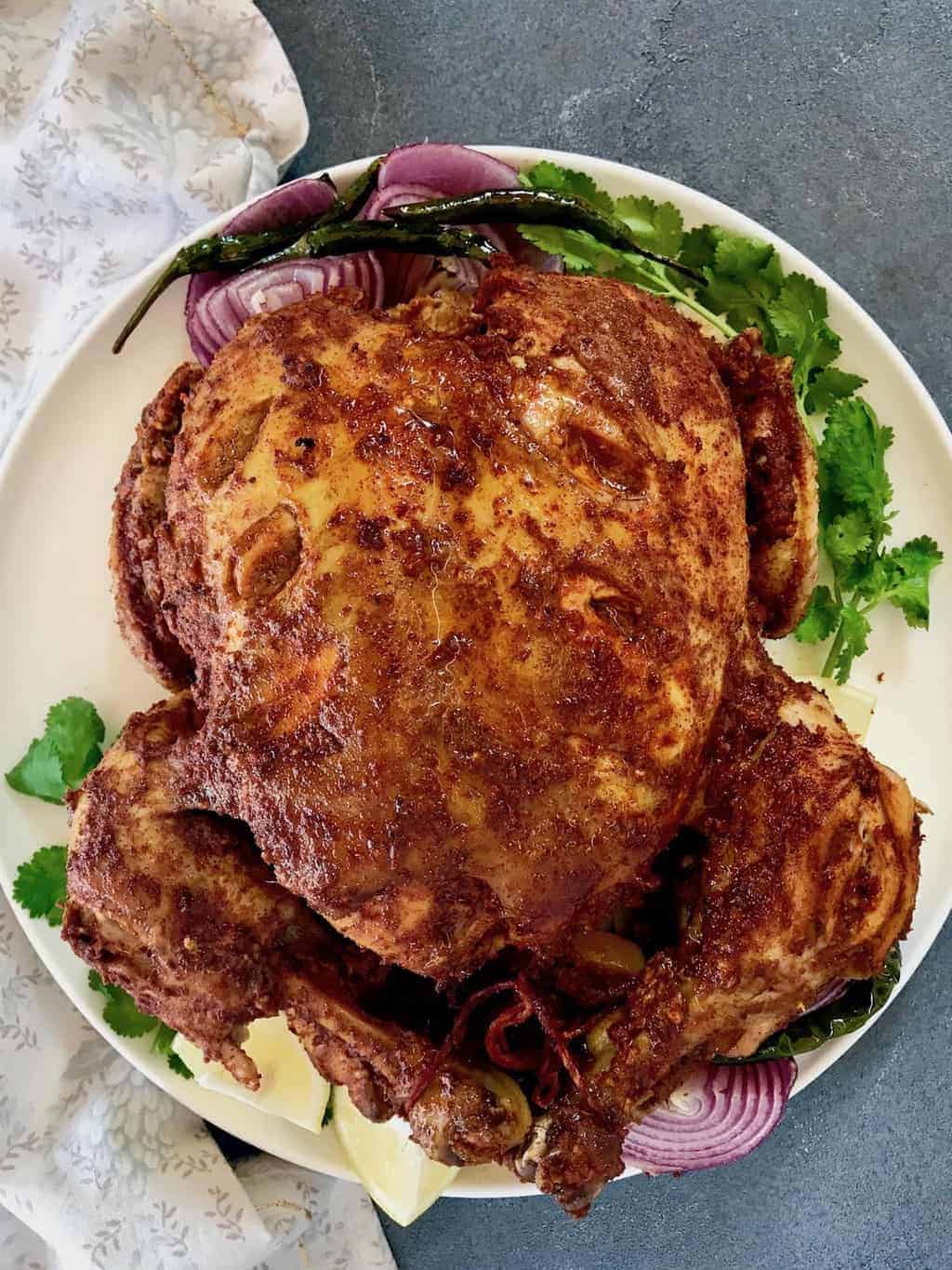 Whole Tandoori Chicken, smothered in a spicy tandoori spice mix served with a flavorful gravy is sure to please your family and friends. #ministryofcurry #instantpot