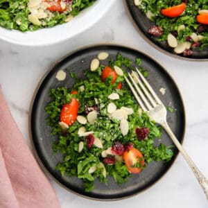 kale salad with tomatoes, almonds and dried cranberries