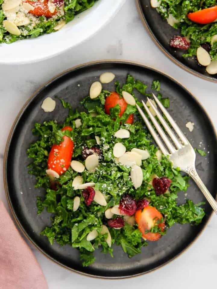 kale salad with tomatoes, almonds and dried cranberries