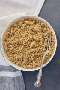 Quinoa in a white bowl with fork
