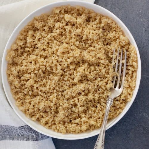 Quinoa in a white bowl with fork