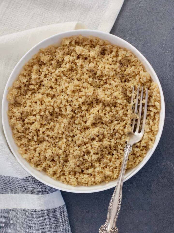 Quinoa in a white bowl with fork