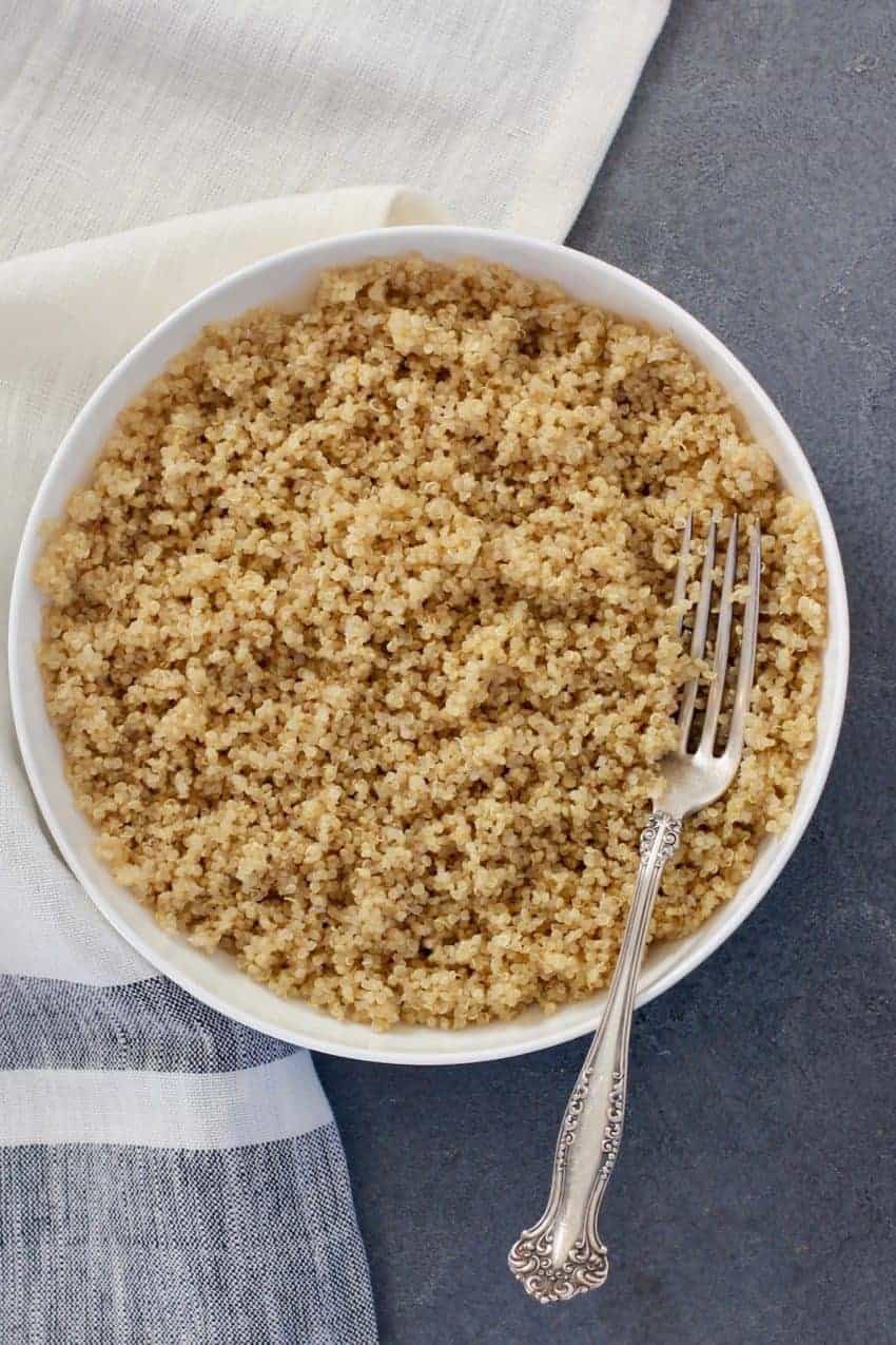 Quinoa in a white bowl with fork 