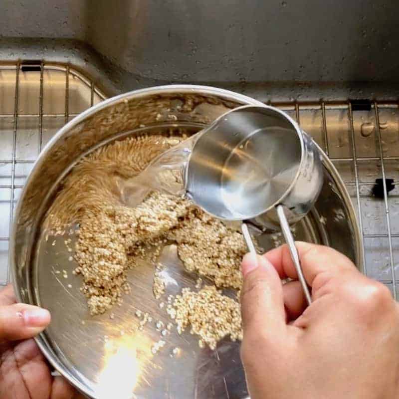 Add quinoa to a stainless steel bowl with water