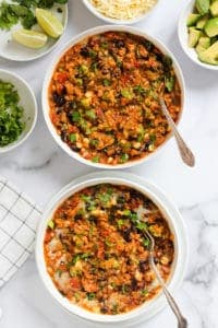 Chicken enchilada quinoa served in 2 white bowls.