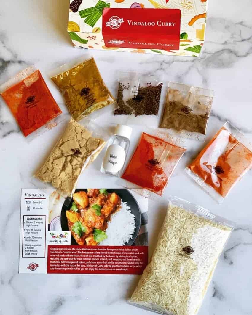 Vindaloo curry pantry kit with all the spices and ingredients laid in front 