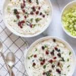 Curd Rice in 2 bowls garnished with cilatro and pomegranate seeds