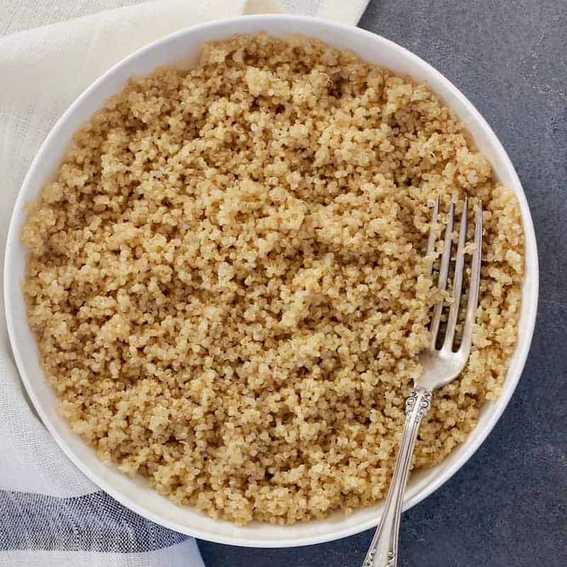 Bowl of cooked quinoa with a fork