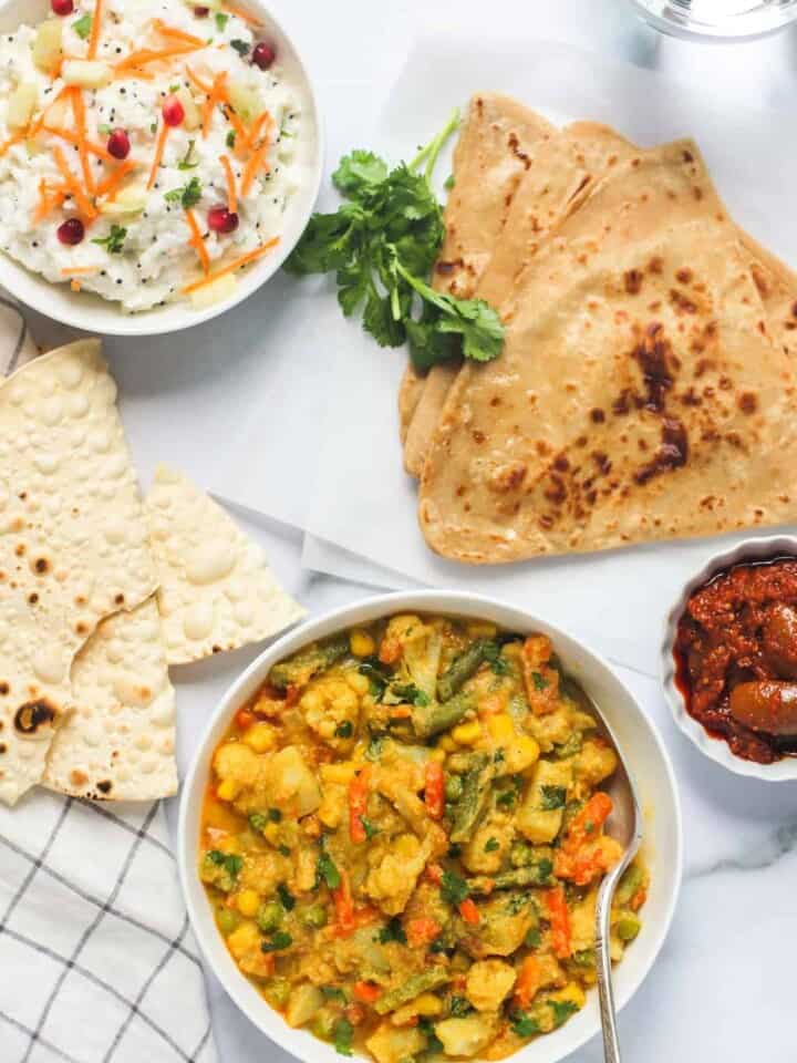 Veg Kurma served with parathas, rice and papad