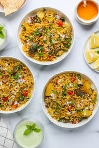 Masale Bhath serevd in 3 bowls with cooling drink on tne side