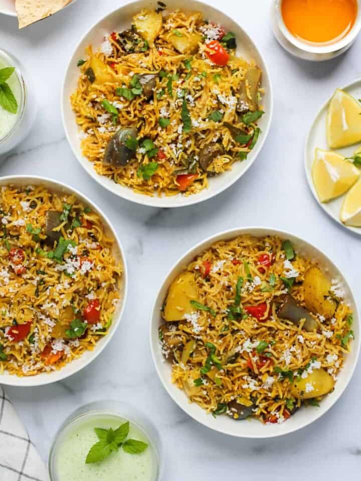 Masale Bhath serevd in 3 bowls with cooling drink on tne side