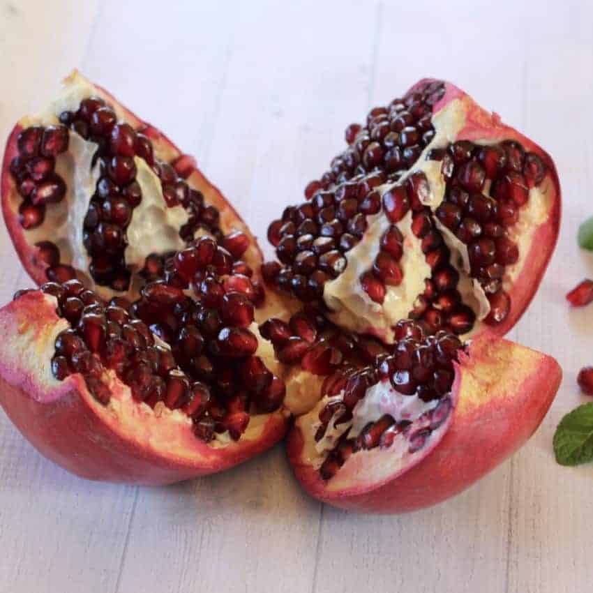 Pomegranate cut open into 4 wedges 
