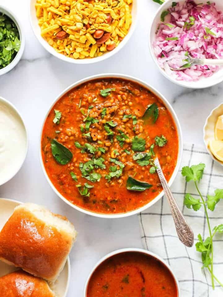 Misal Curry served in a big bowl with all the condiments on the side