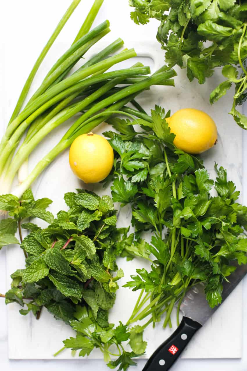 herbs and lemons on cutting board 