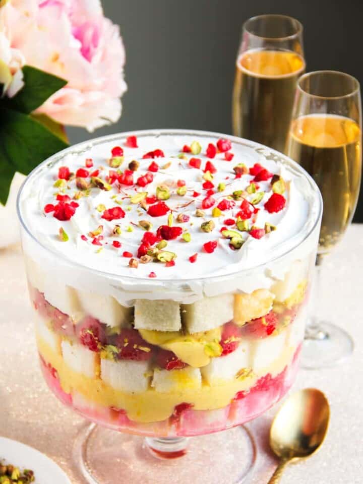 A show stopper dessert, this no-cook Raspberry Trifle is layered with light angel food cake, cardamom & saffron infused pudding, pistachios and cream.