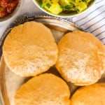 Puri in silver plate with potato bhaji and pickle