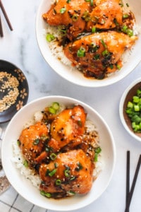 Chicken Teriyaki served in 2 white bowls with rice