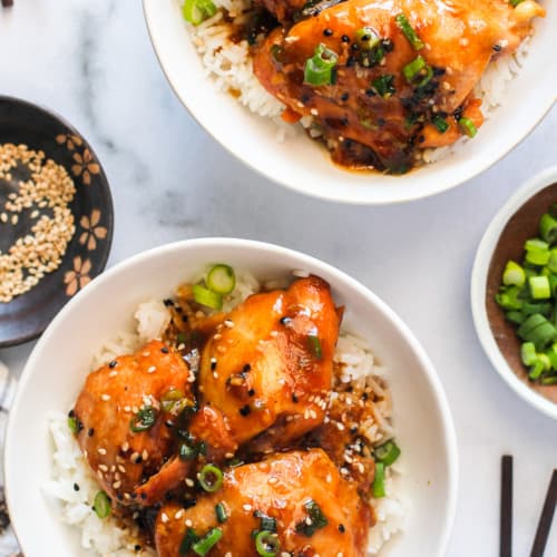 Chicken Teriyaki served in 2 white bowls with rice